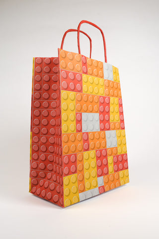 sacchetto mattoncini lego arancione, rosso e giallo profilo 45 gradi