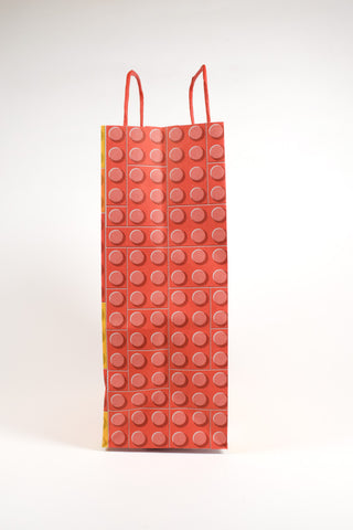sacchetto mattoncini lego arancione, rosso e giallo vista laterale